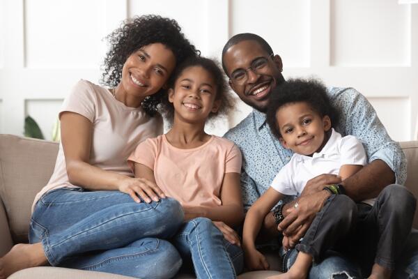 a family sitting on a couch